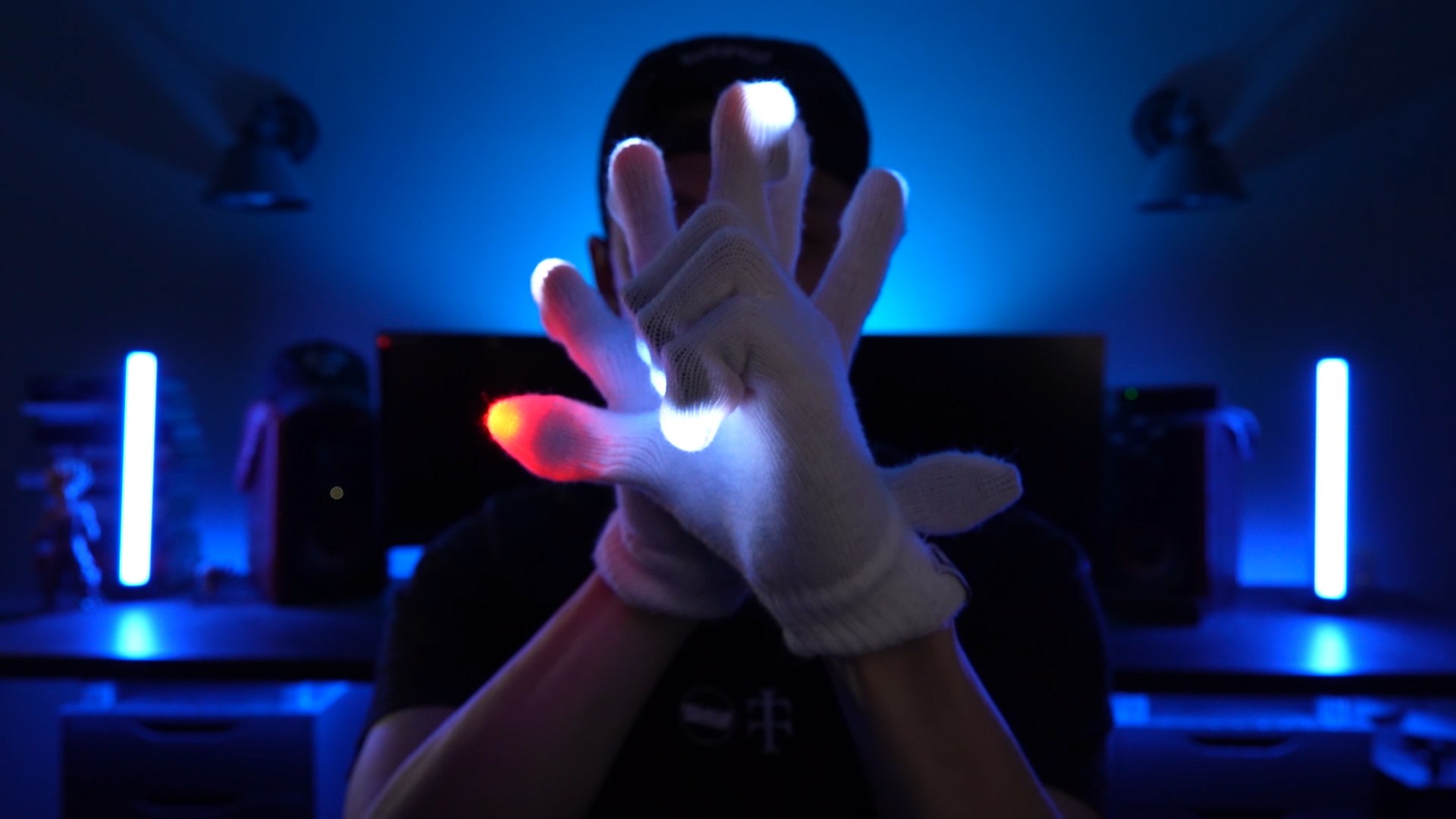 Glover crossing lit hands mid-choreography