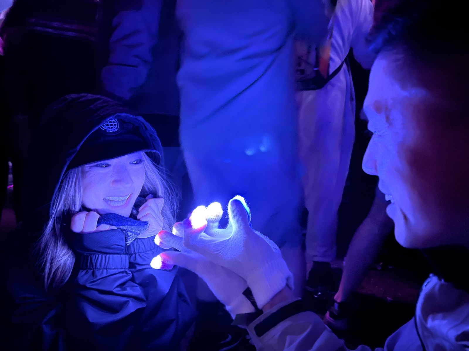 Smiling festival-goer watching a lightshow up close